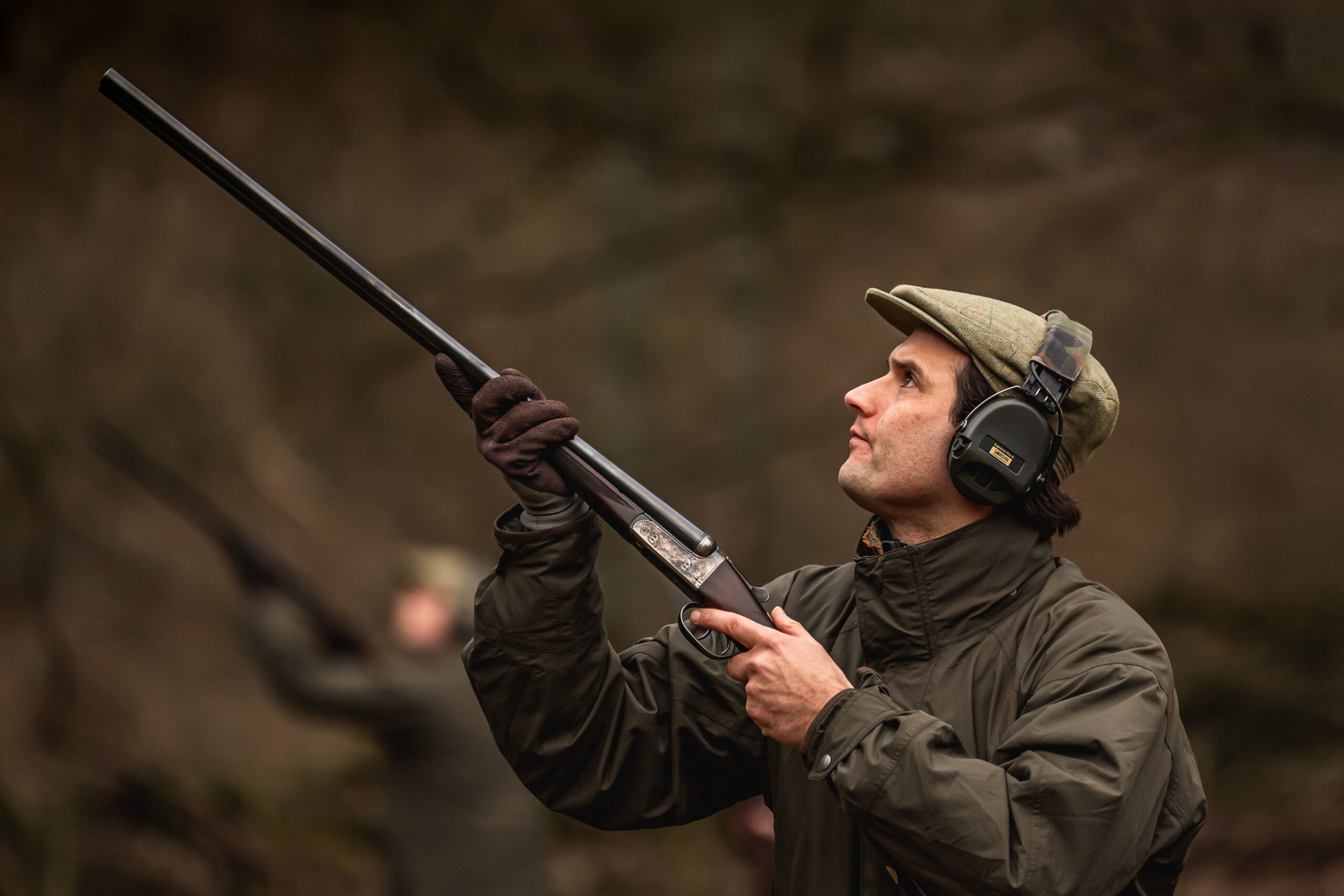 Man stood on peg with gun ready for birds to come over