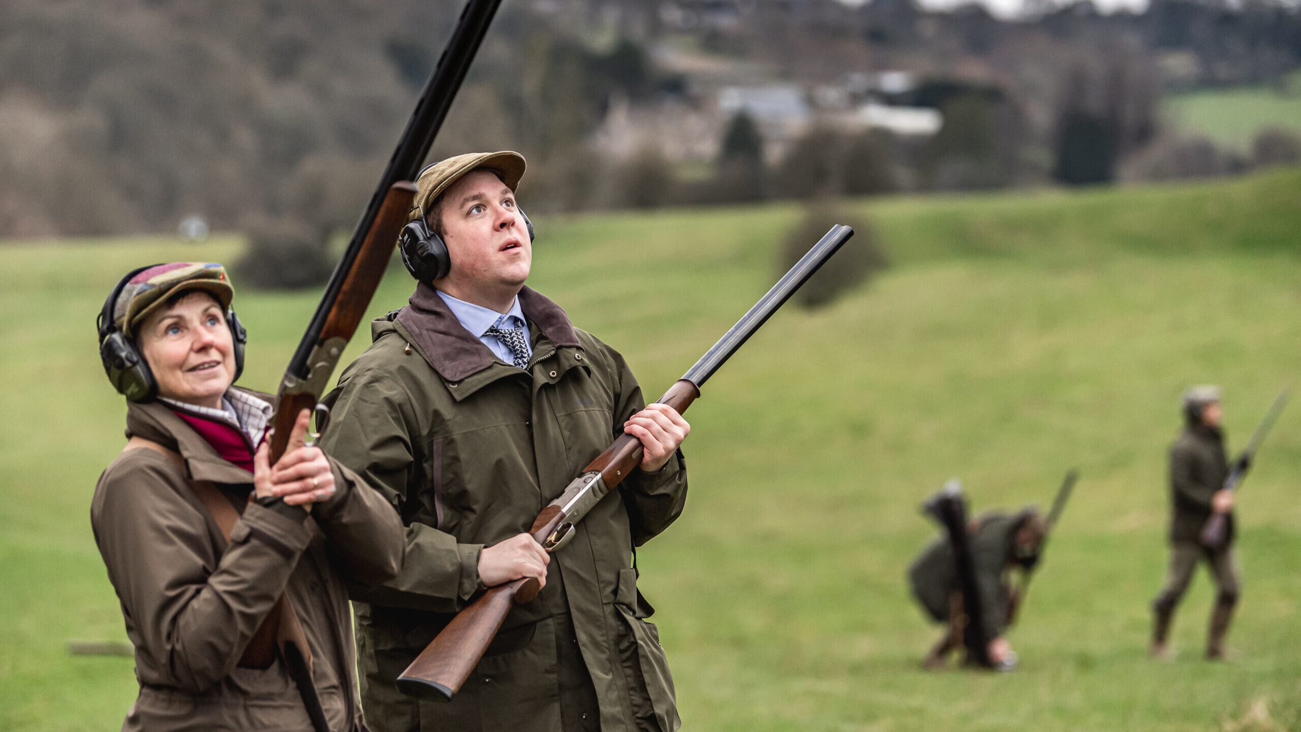 Female gun with male loader stood waiting for drive to begin