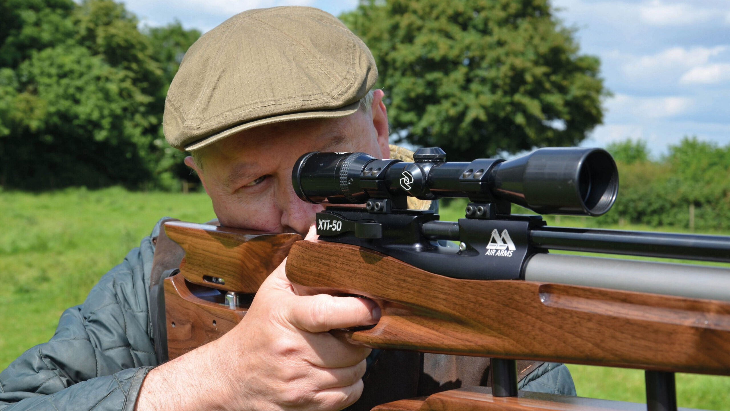 Man looking down the scope of a rifle