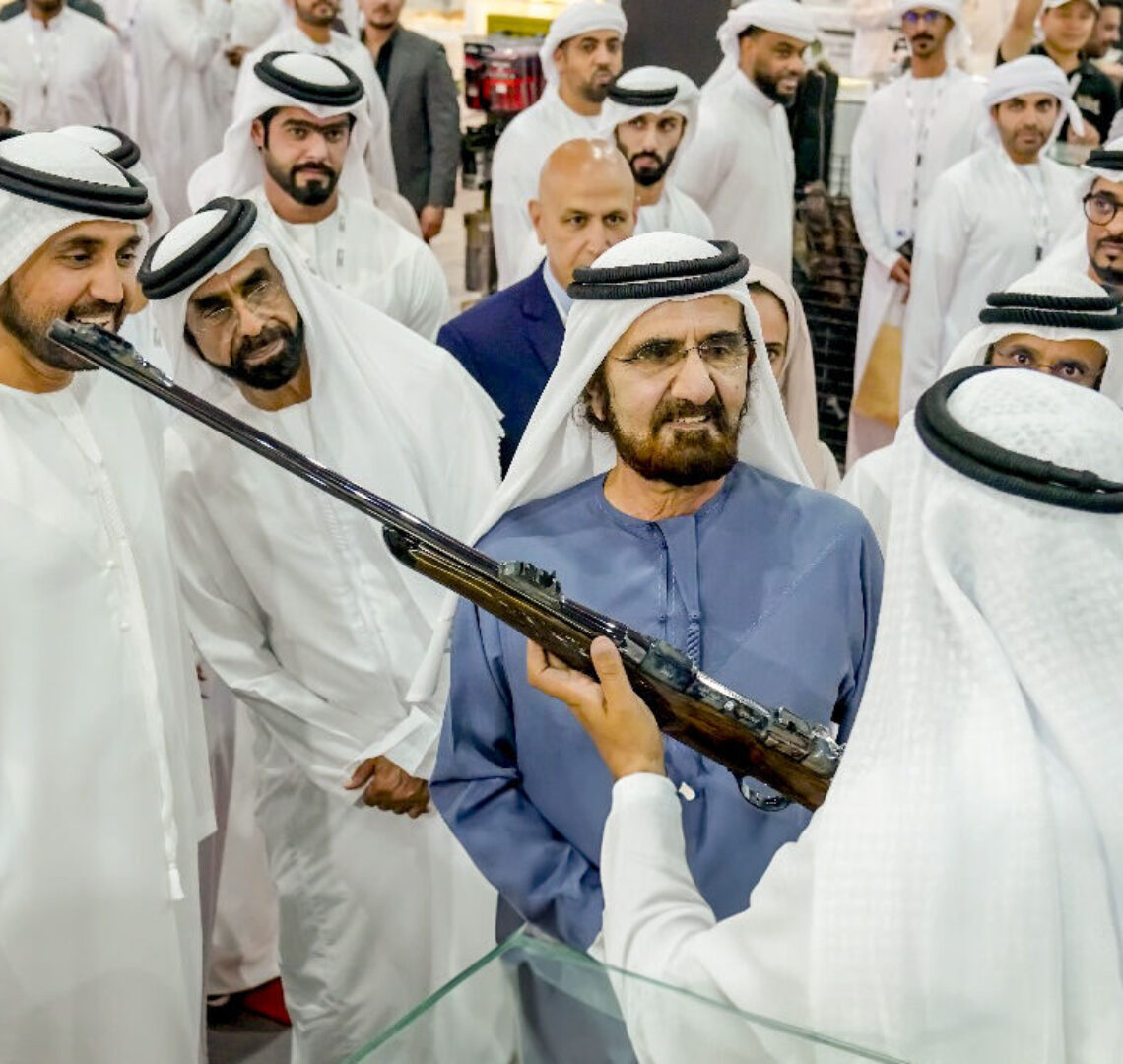 His Highness Sheikh Mohammed bin Rashid Al Maktoum, Vice President and Prime Minister of the UAE and Ruler of Duba being shown a gun whilst at the Middle East Hunting Expo.